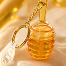Lip Gloss Honey Kiss Miamake Chaveiro Hidratante Cheiro de Mel Formato Colmeia